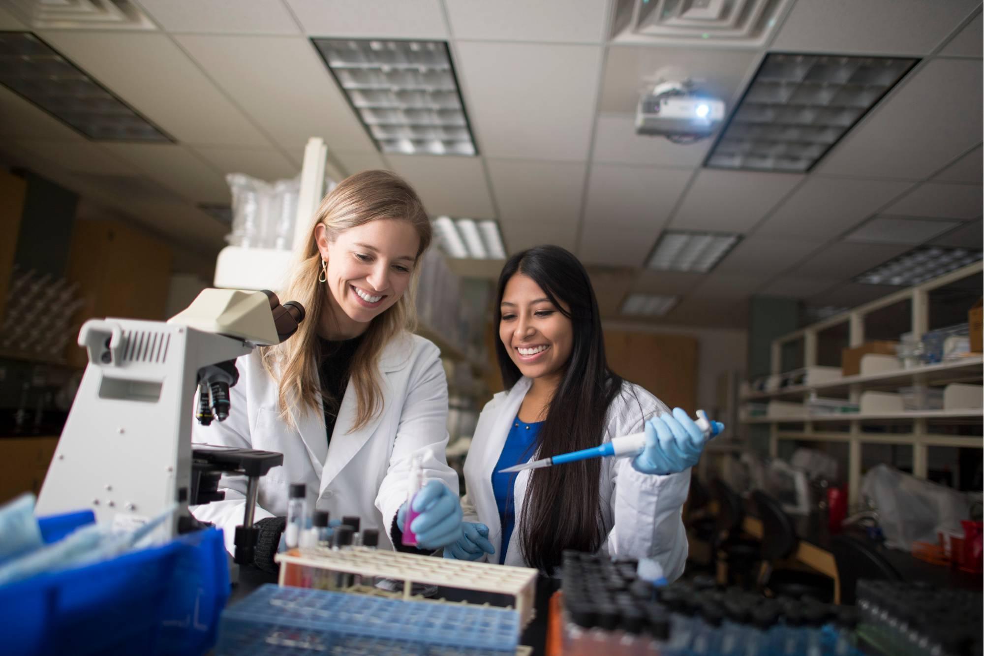 A GVSU student works with a faculty member in a lab.
